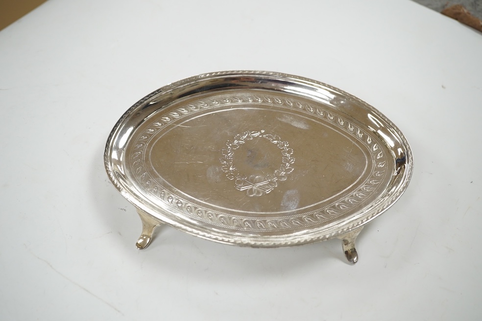 A George III engraved silver oval teapot stand, London, 1796, on four swept feet, 17.3cm, 137 grams. Condition - poor.